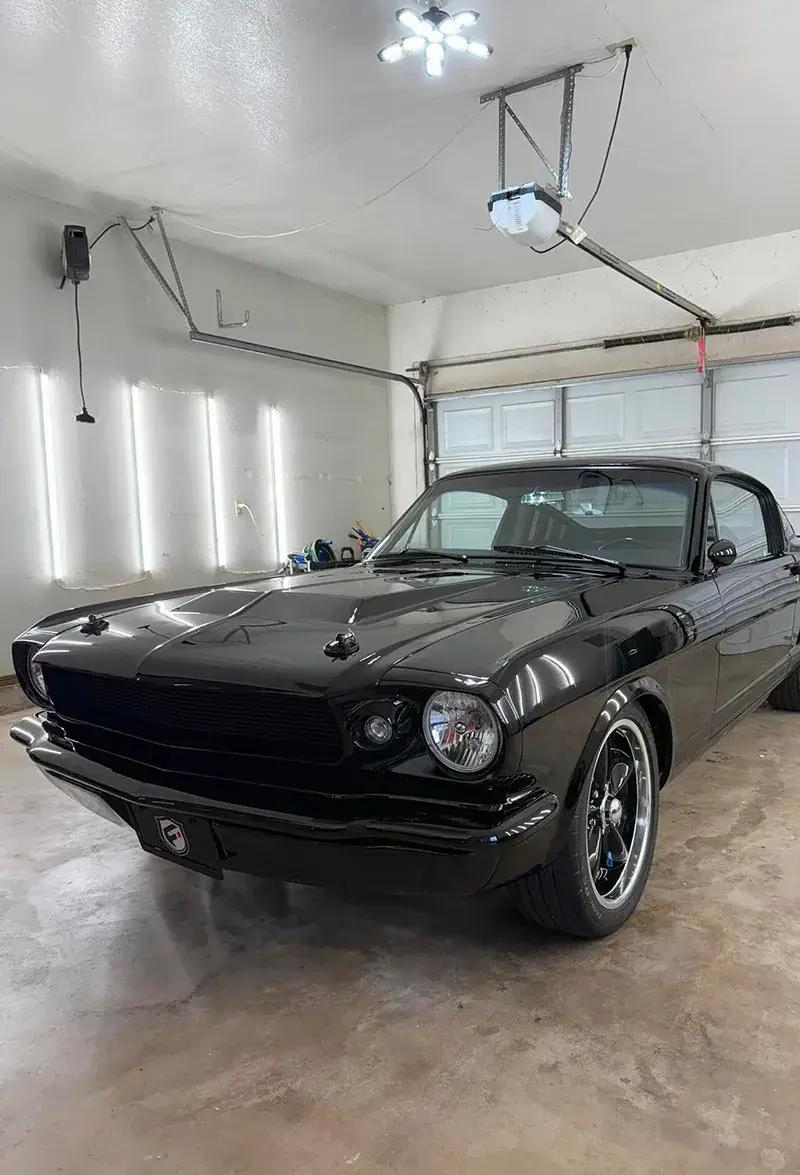 Black classic vehicle in DL Fine Auto shop